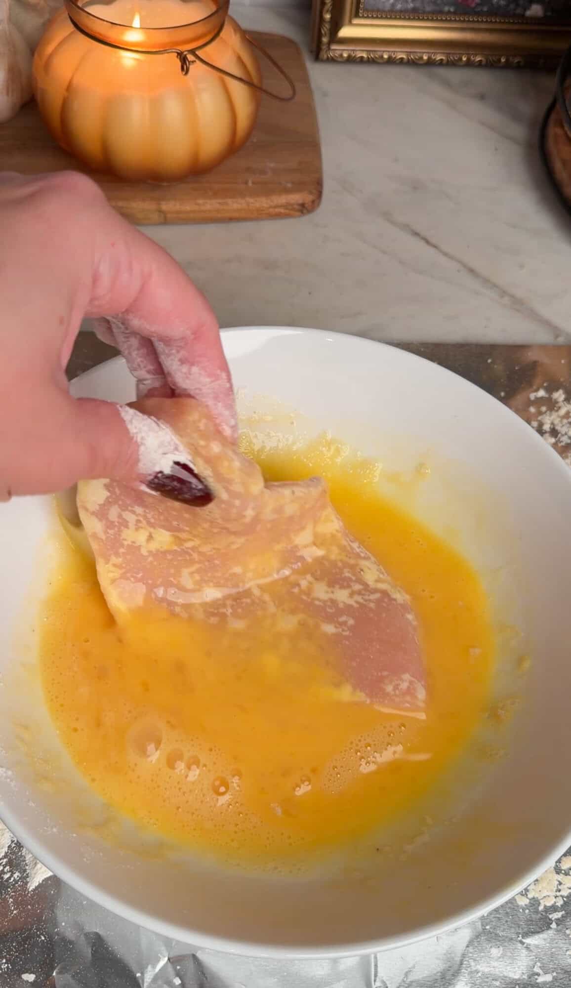 dipping chicken in egg wash