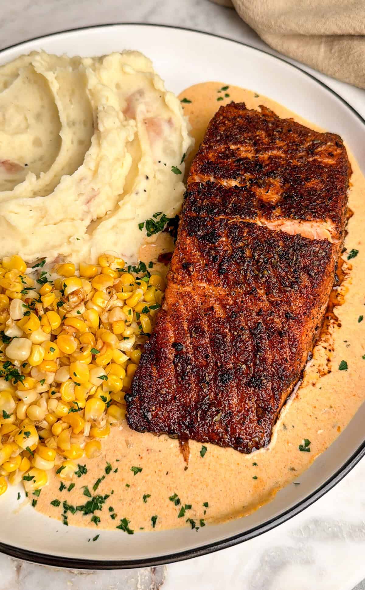cajun salmon on a bed of cajun cream sauce