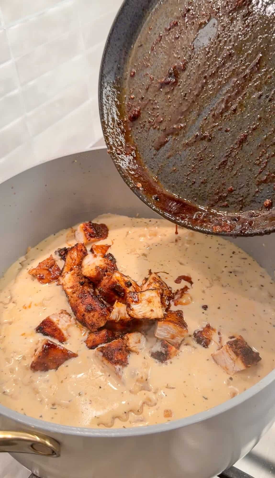 adding blackened chicken to chicken alfredo soup