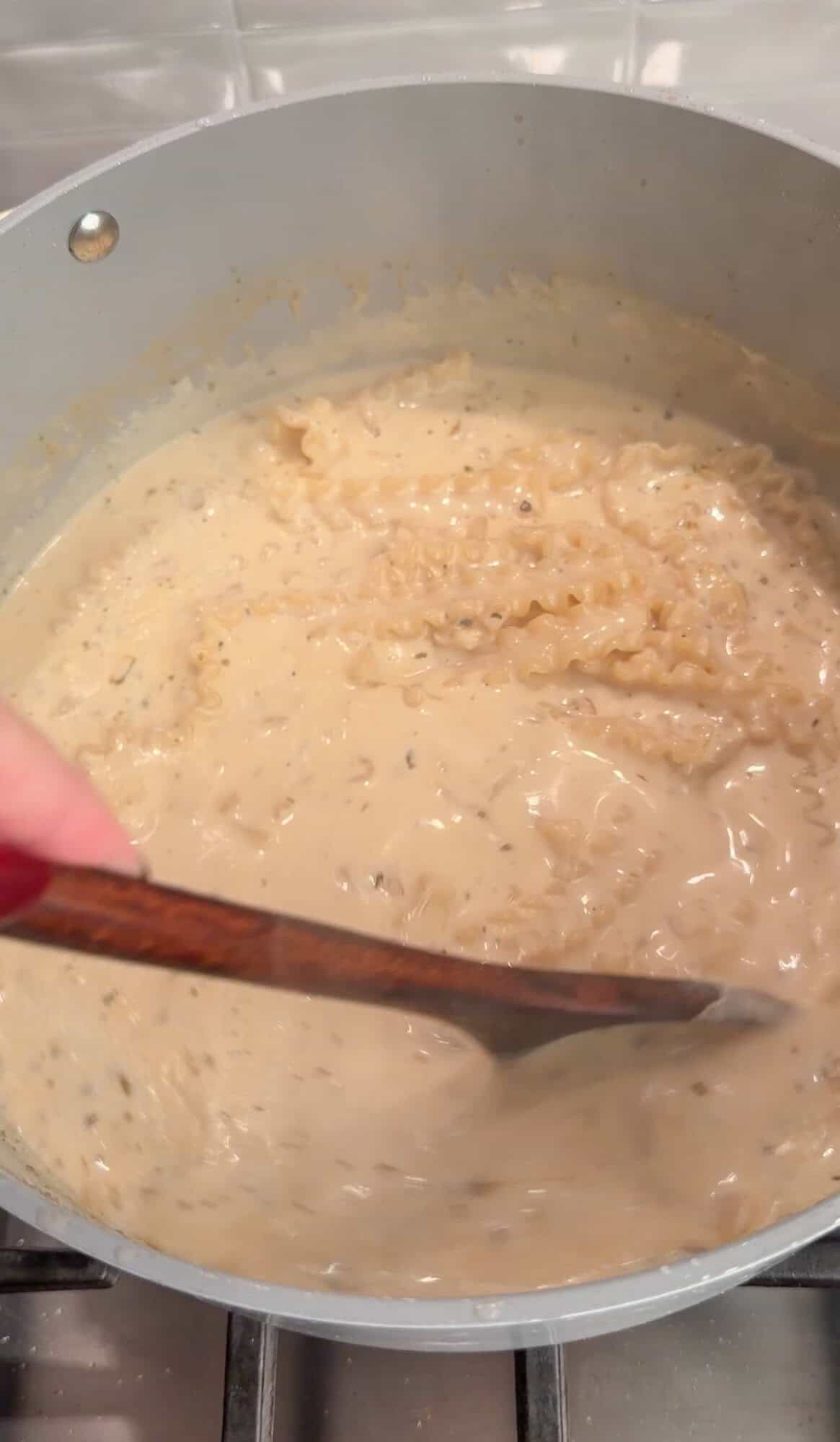 adding pasta to chicken alfredo soup