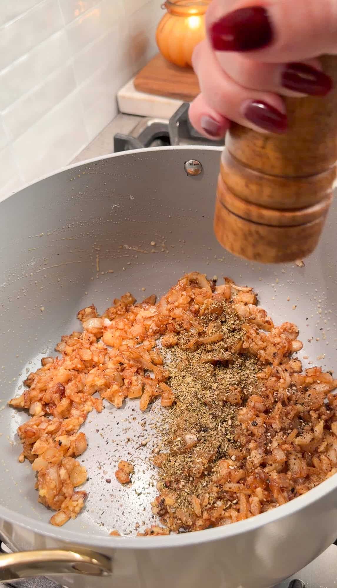adding seasonings to chicken alfredo soup