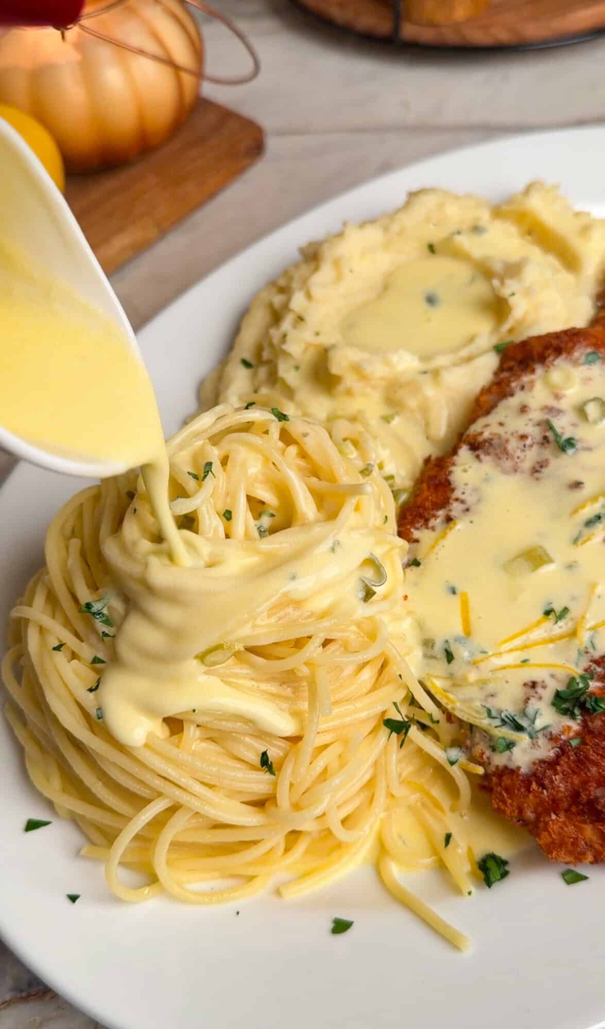 creamy lemon sauce over pasta, mashed potatoes and chicken costoletta