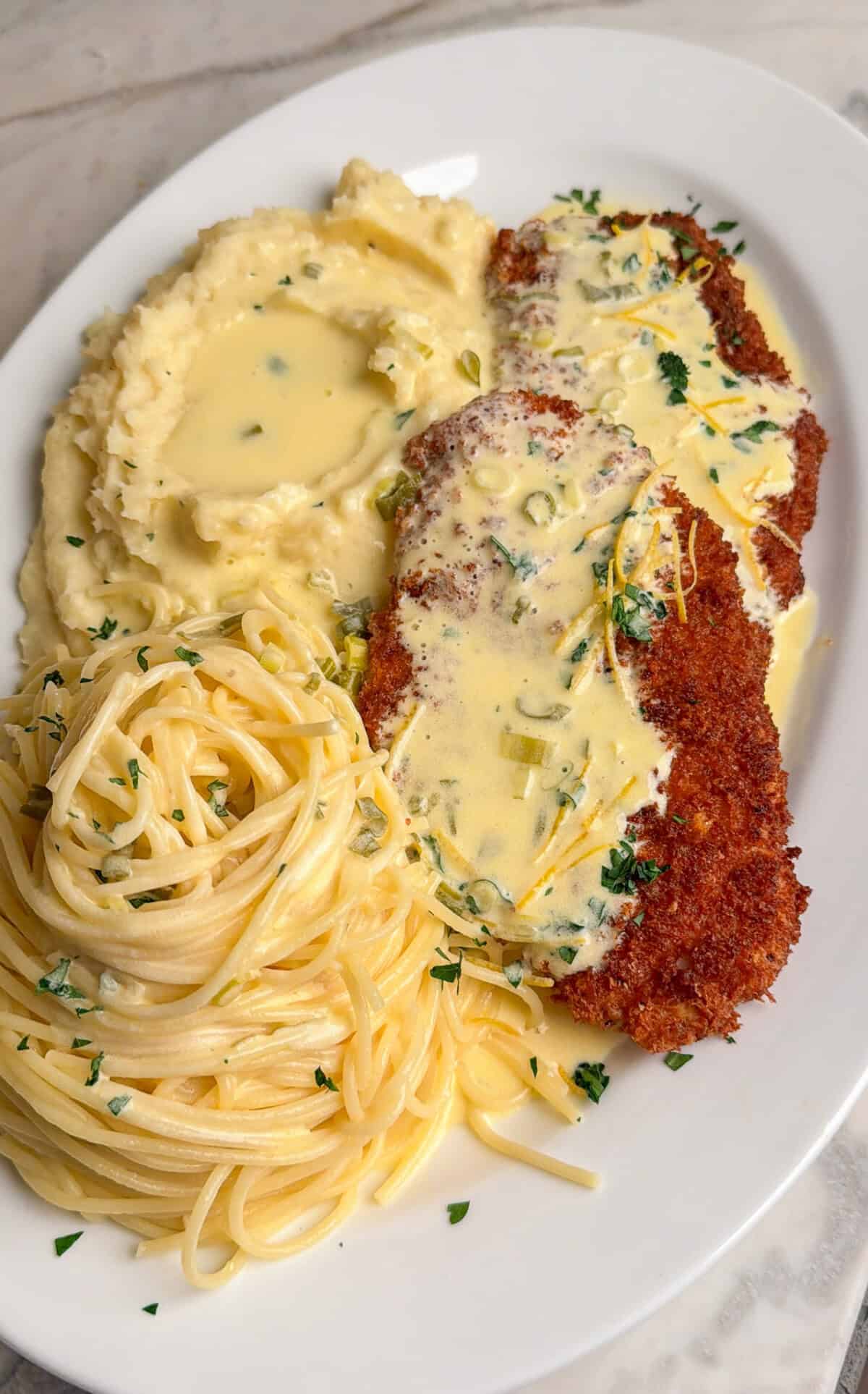 chicken costoletta with pasta and mashed potatoes
