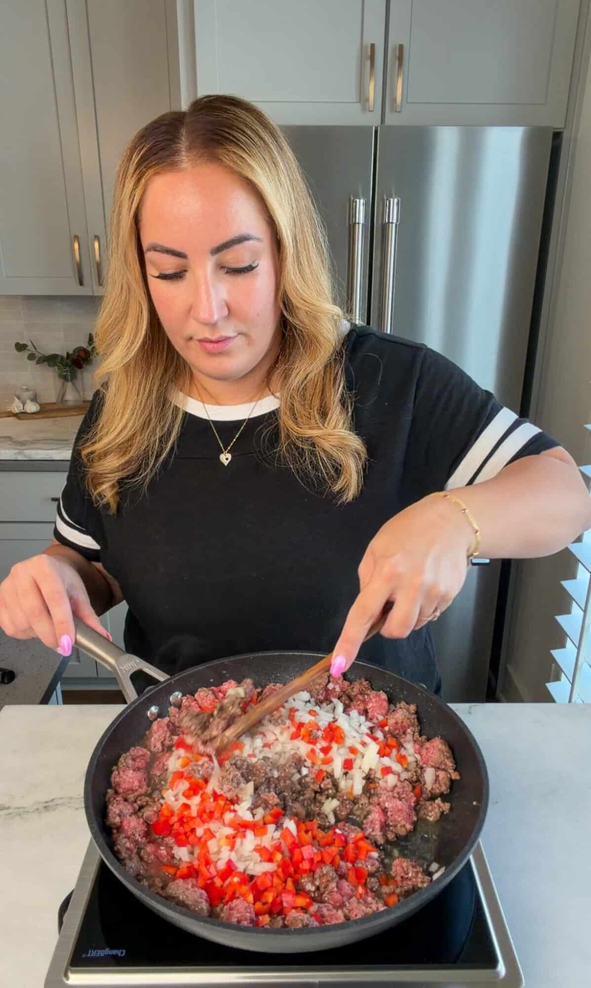 Browning the beef and adding the veggies to homemade sloppy Joes filling.