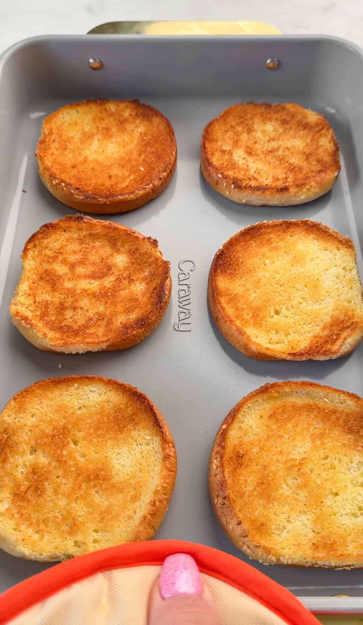 Toasted buns in a baking pan.