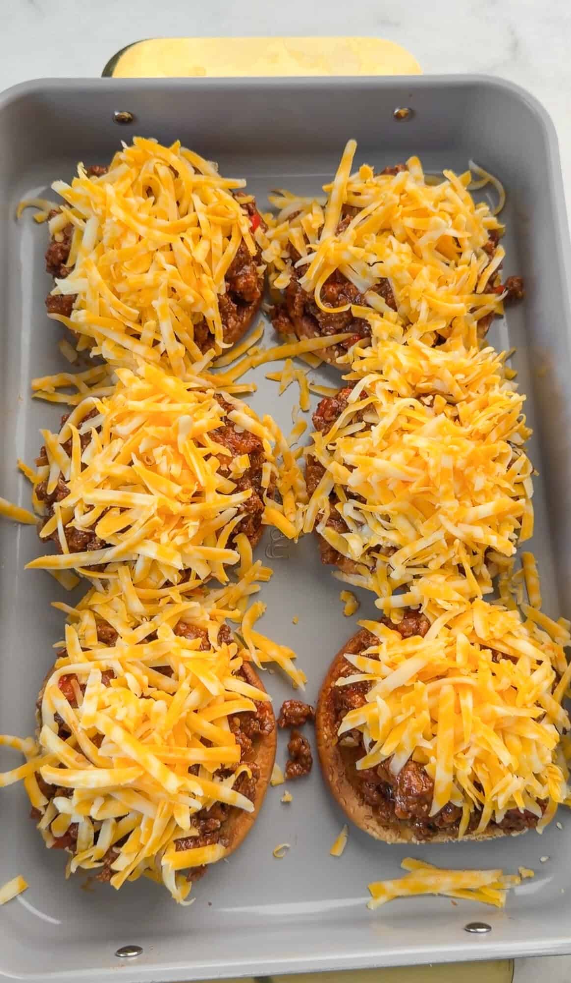 Open-faced sloppy Joes topped with shredded cheese.