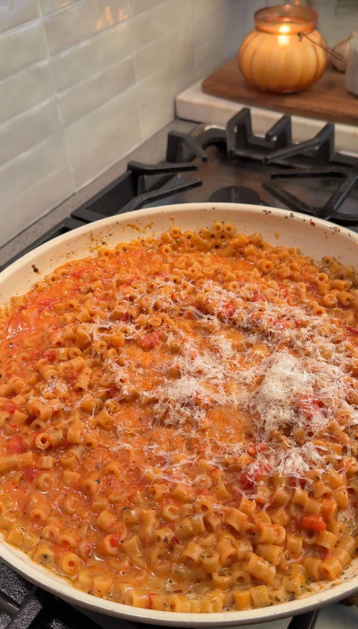 adding the parmesan to meatball pasta