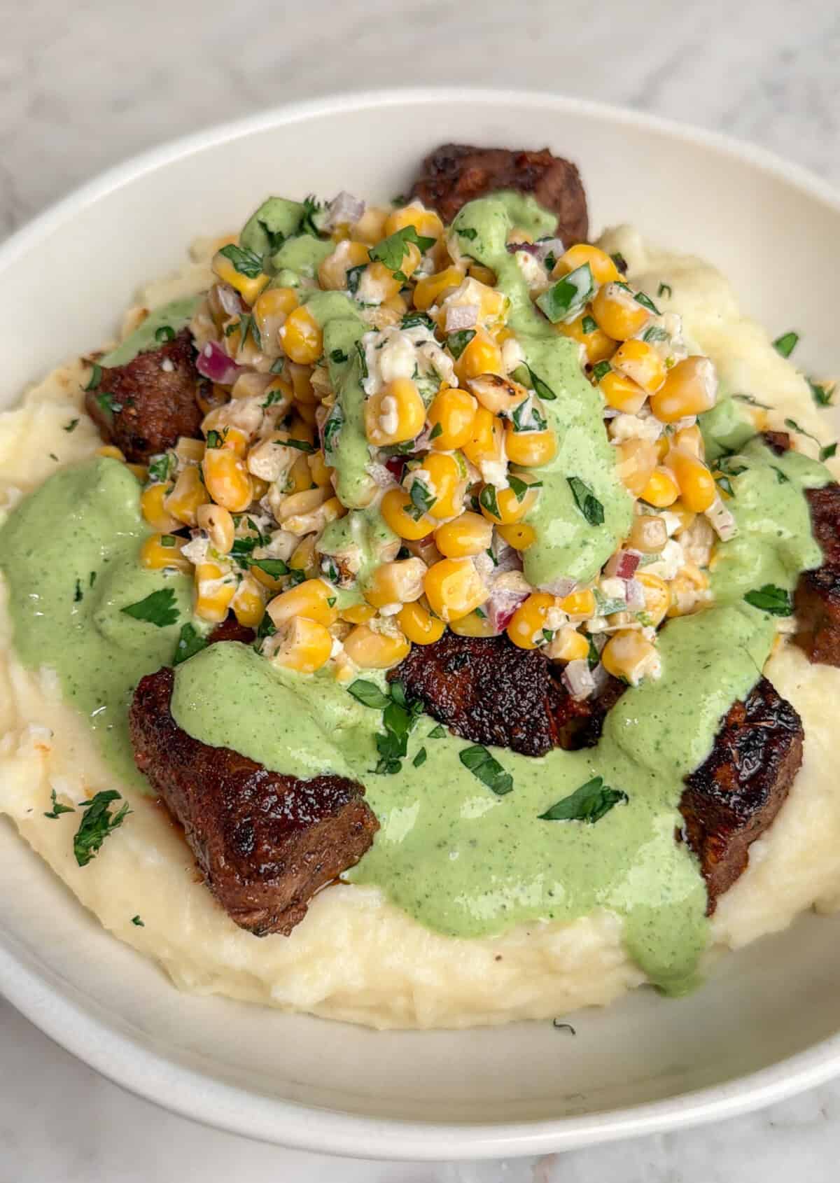 steak bowls with mashed potatoes, street corn and aji verde