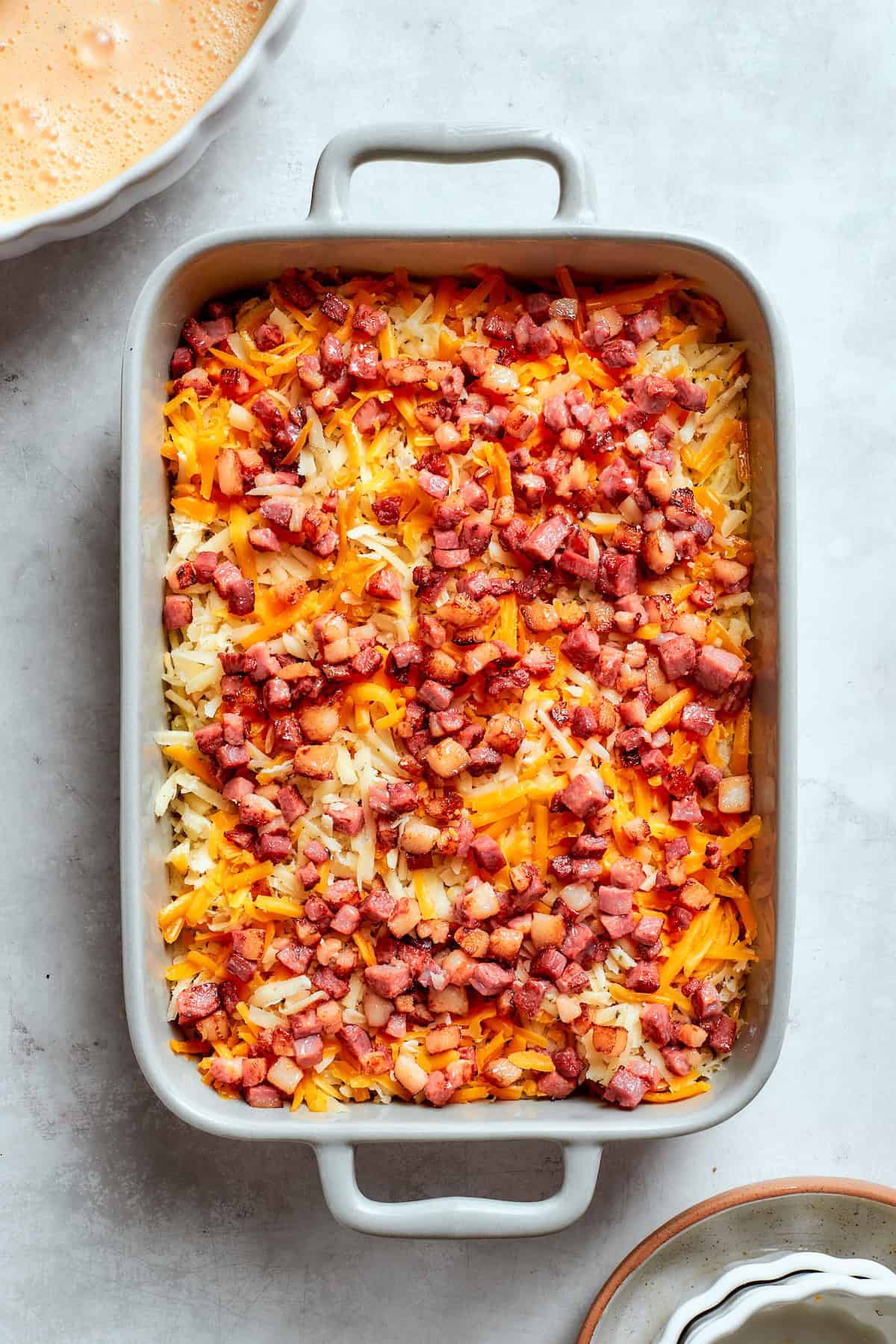 Loaded with bacon, eggs, and cheese and baked in one dish, this hashbrown breakfast casserole is the easiest way to do brunch for a crowd. Pre-baked hashbrowns tossed with cheese and bacon in a casserole dish.