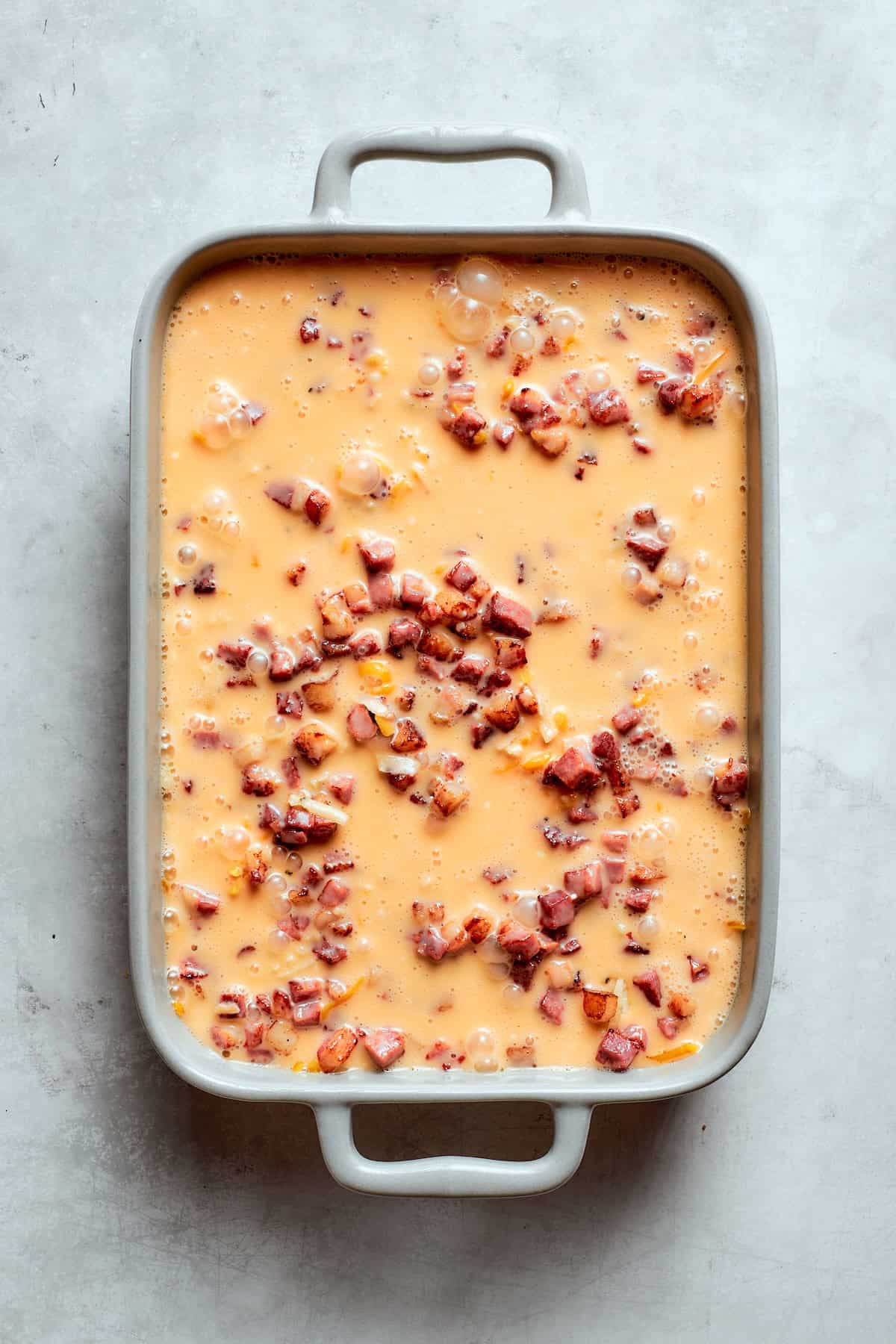 Loaded with bacon, eggs, and cheese and baked in one dish, this hashbrown breakfast casserole is the easiest way to do brunch for a crowd. Pre-baked hashbrowns tossed with cheese and bacon and covered with a mixture of eggs, heavy cream, seasonings, and hot sauce.