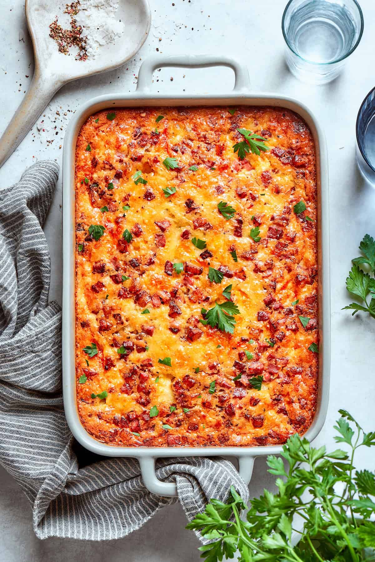 Loaded with bacon, eggs, and cheese and baked in one dish, this hashbrown breakfast casserole is the easiest way to do brunch for a crowd. Overhead of hashbrown breakfast casserole.