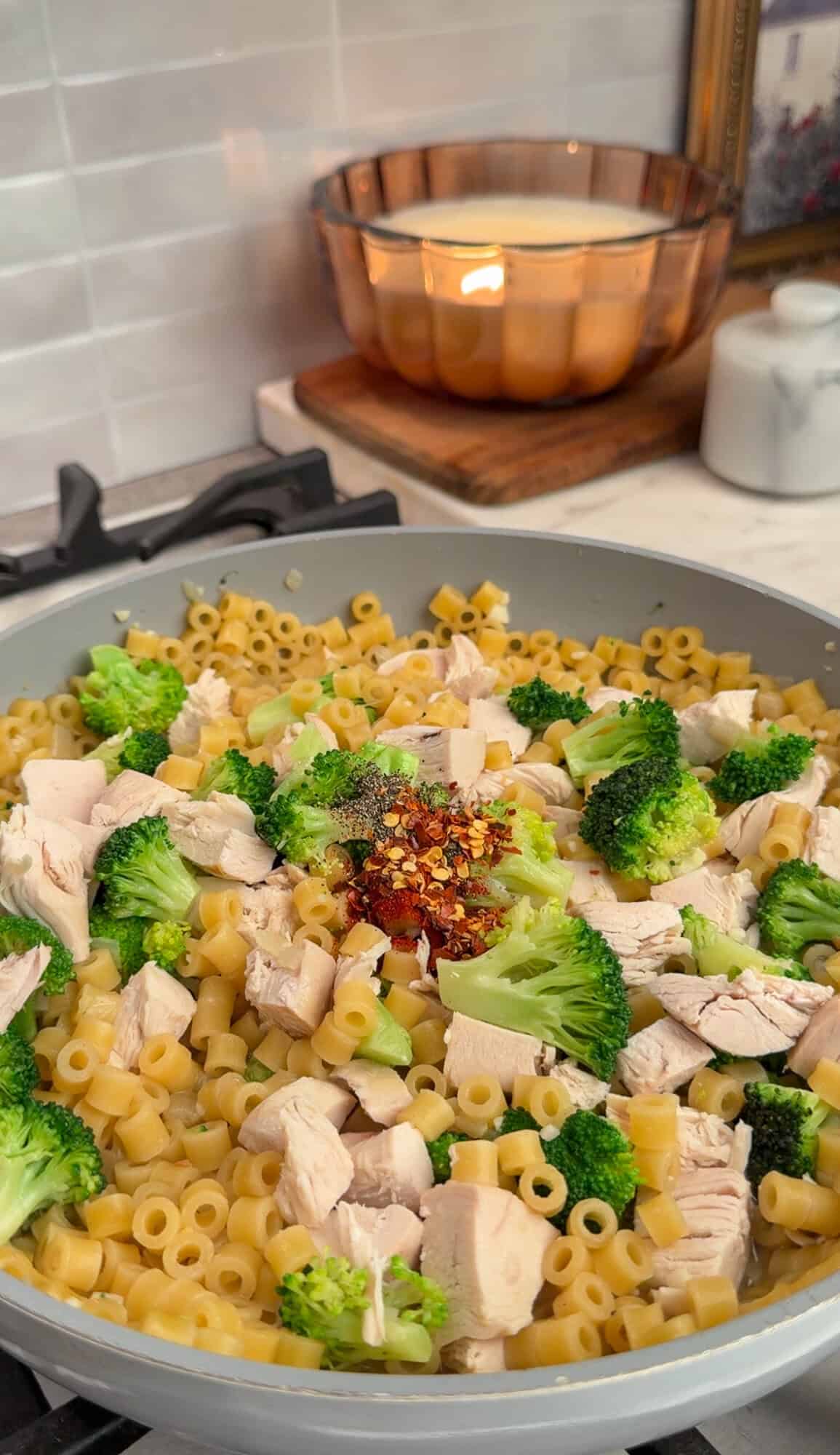 adding broccoli and chicken to one-pot broccoli cheddar pasta