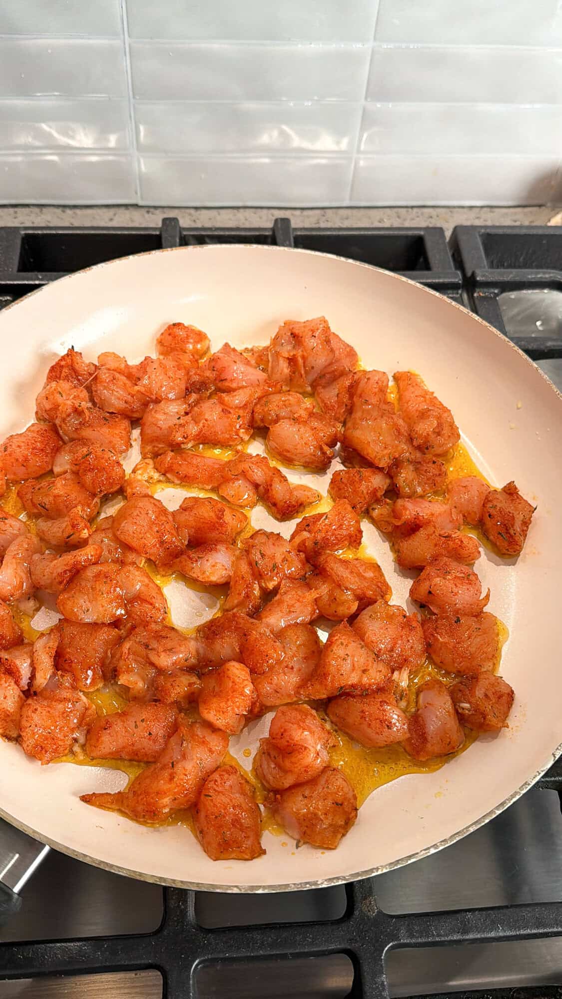 cooking chicken in a skillet for cheesy chicken and rice bake