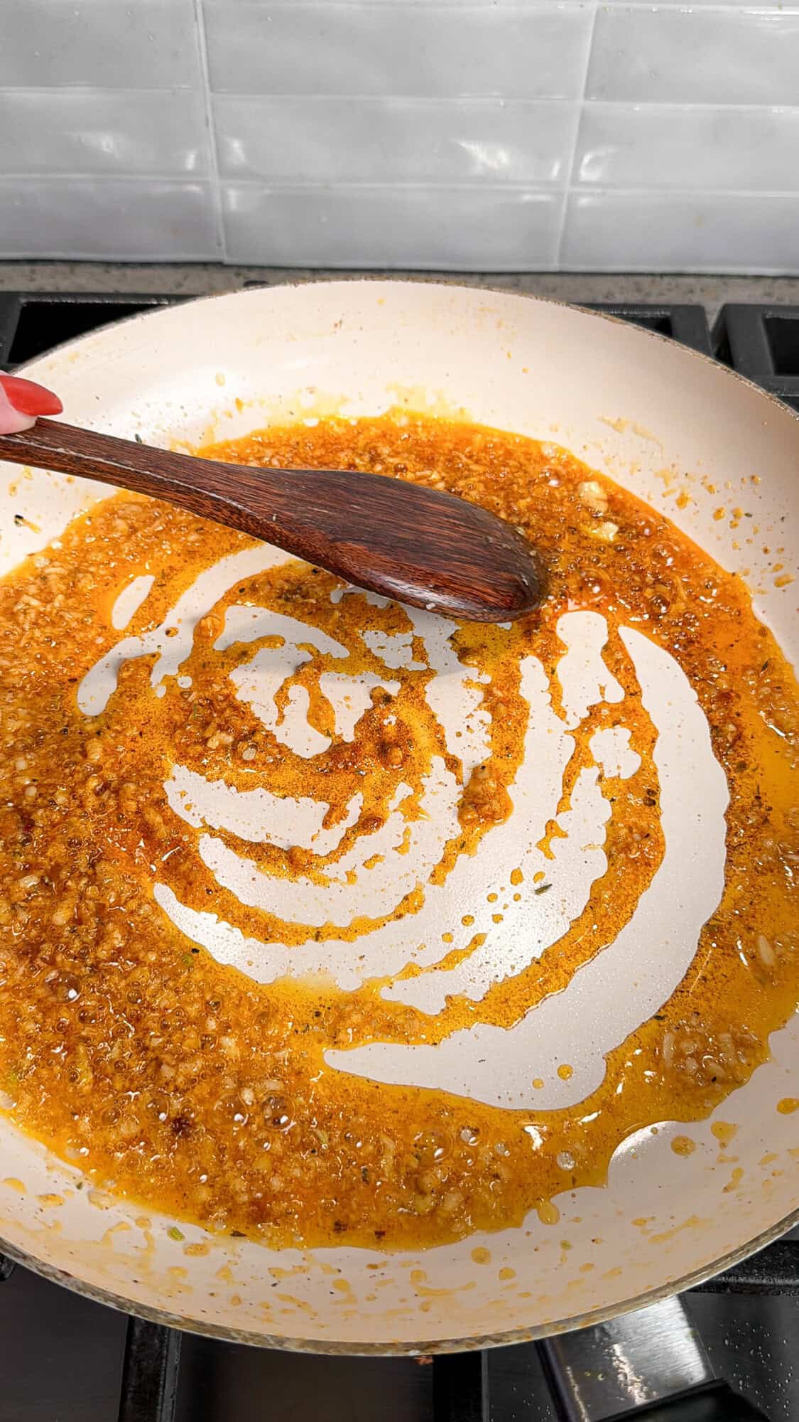 adding seasonings for garlic parmesan cream sauce