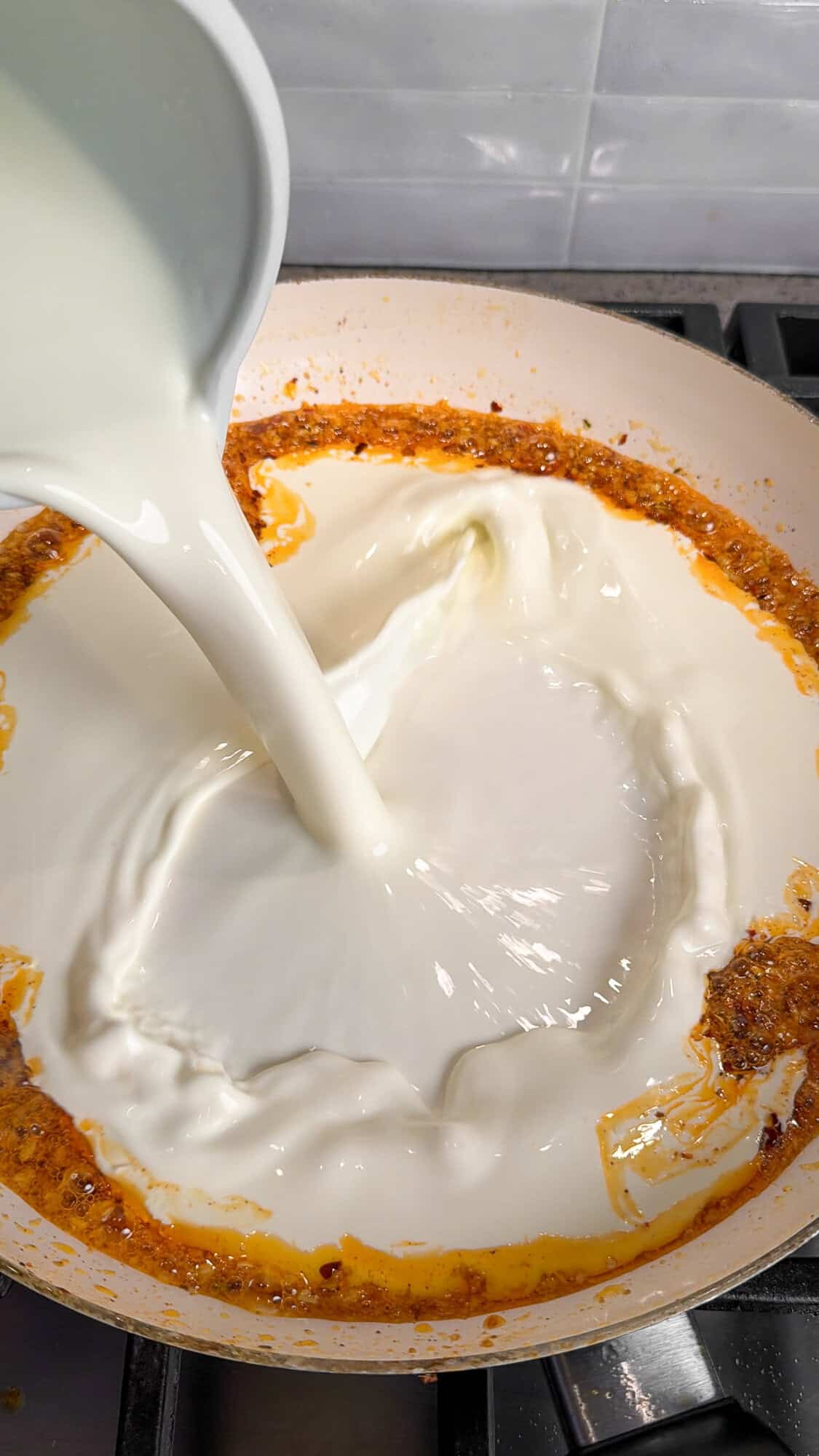 adding half and half for the garlic parmesan cream sauce