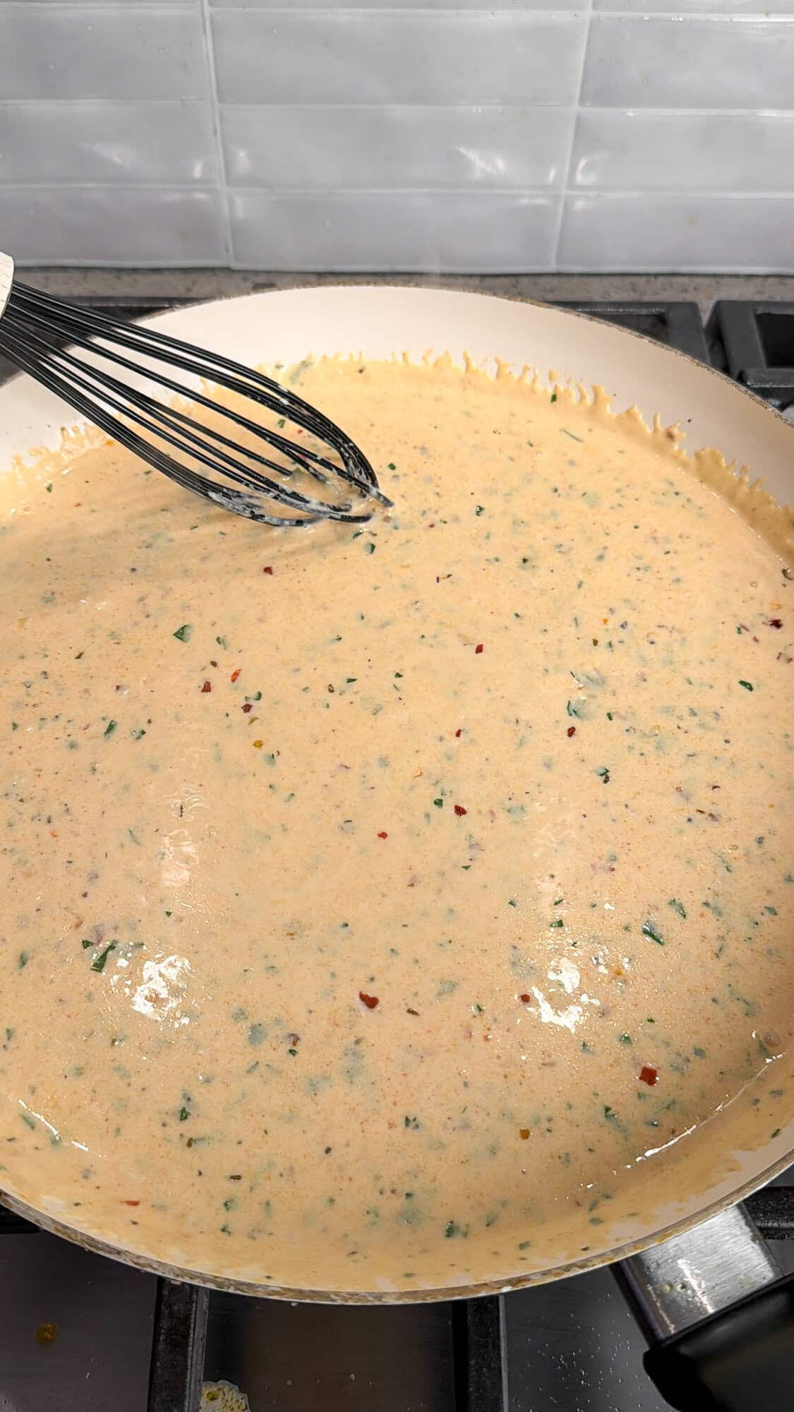 garlic parmesan cream sauce cooking in a pan