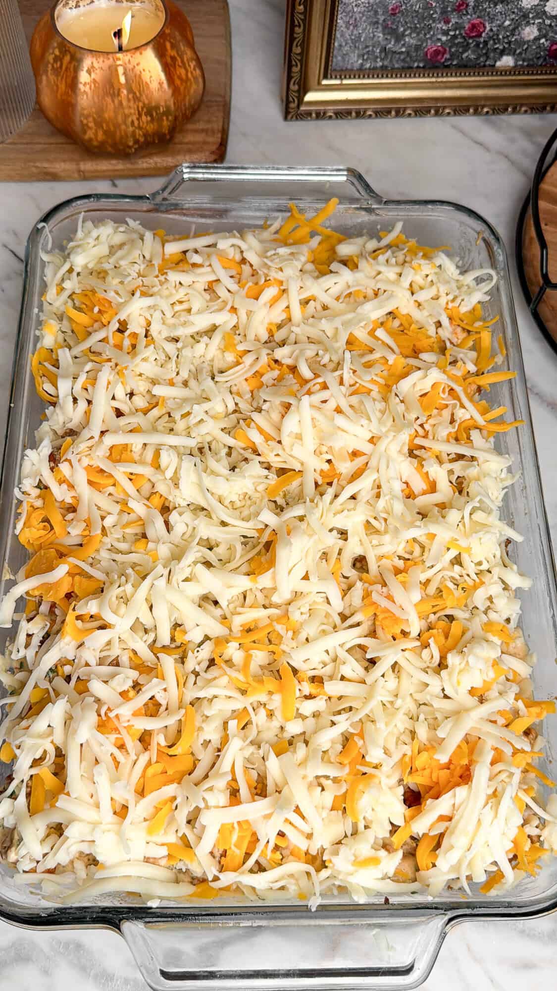 topping cheesy chicken and rice casserole with cheese