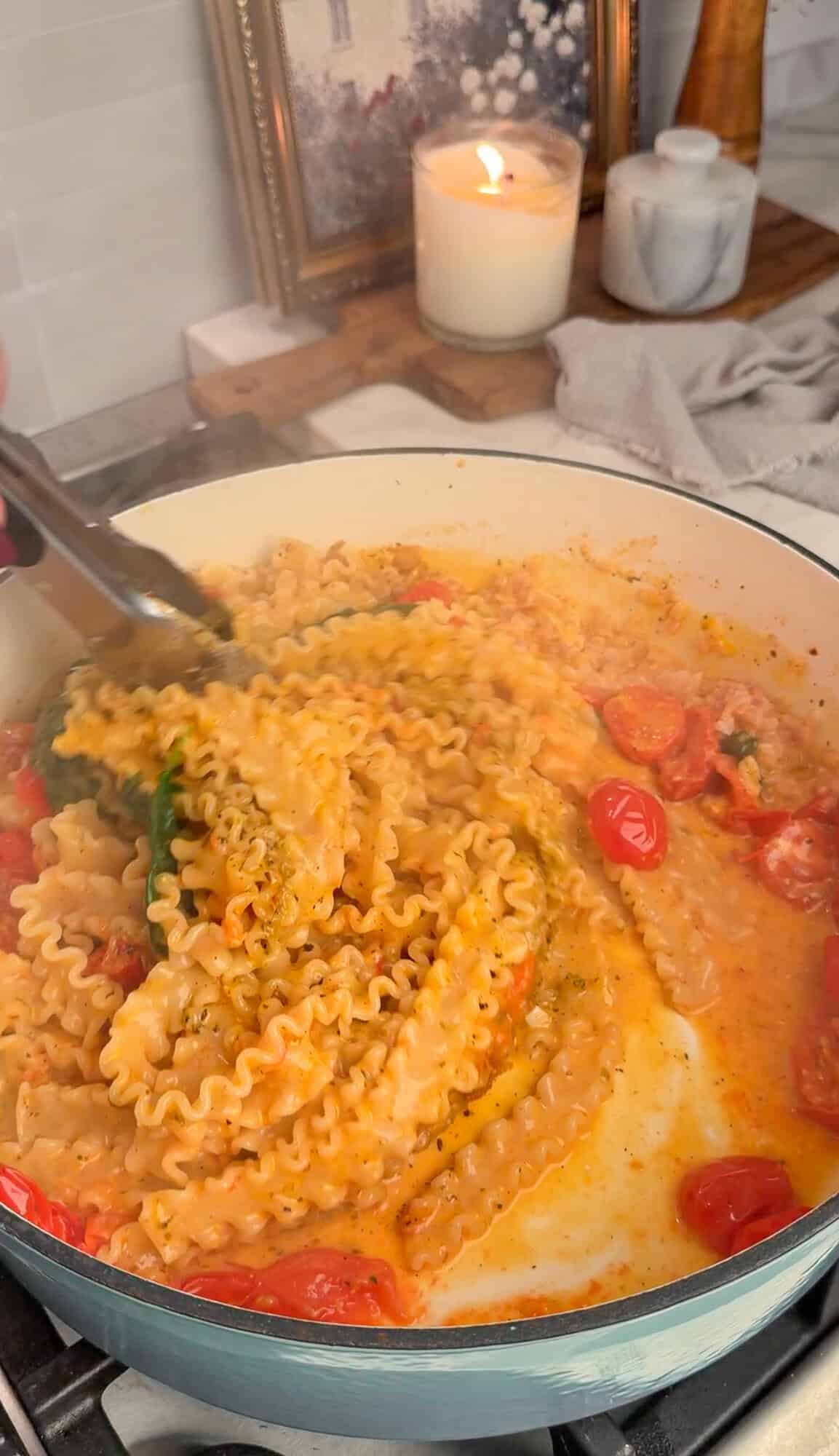 tossing the pasta in the pan sauce after it's done cooking