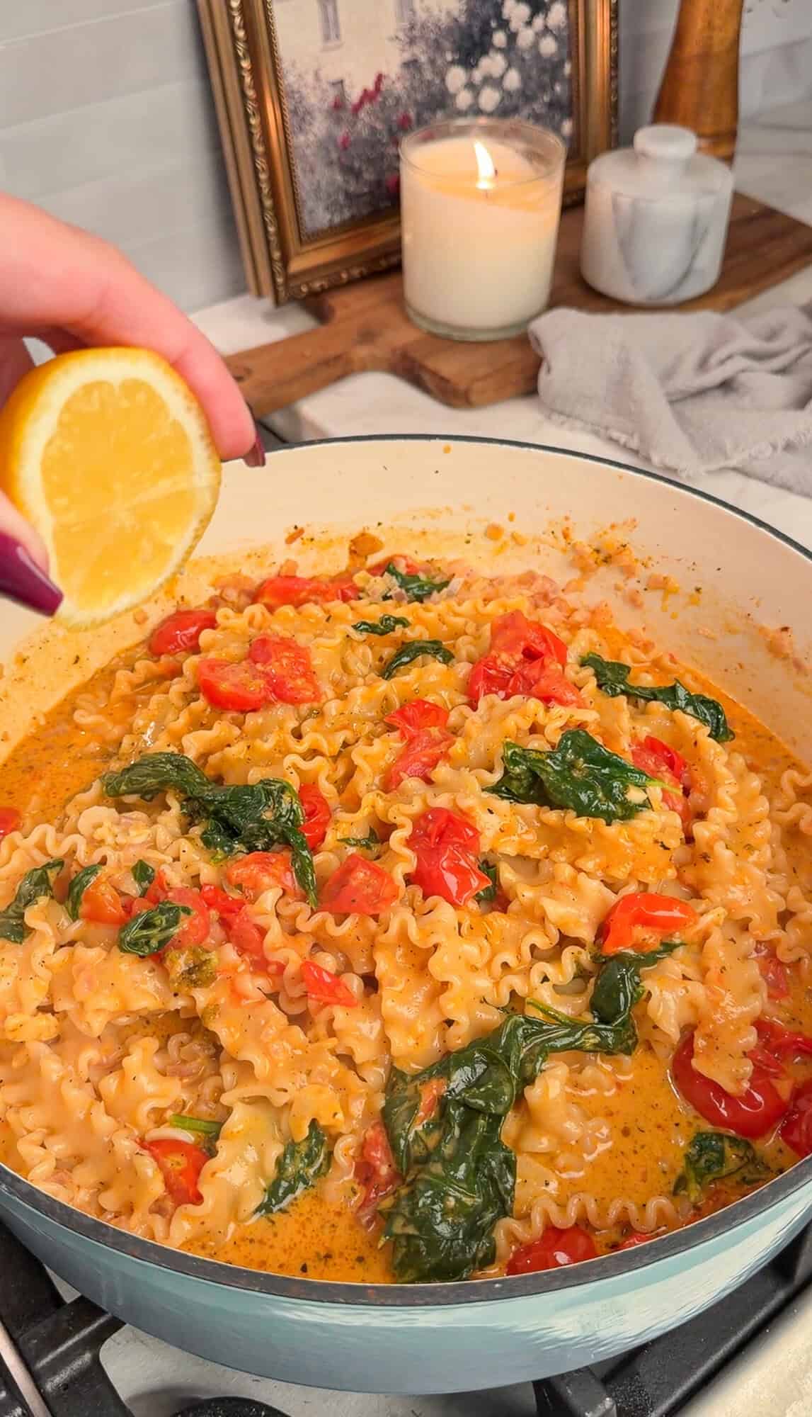 squeezing lemon over the pasta